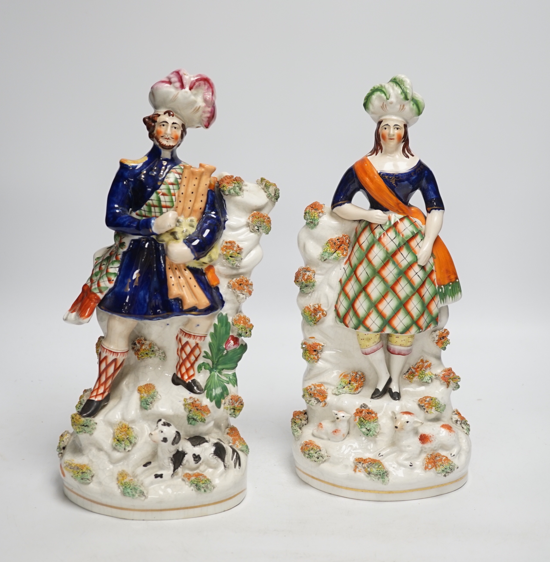 A pair of Victorian Staffordshire figures of Scots musicians